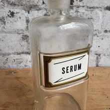 Load image into Gallery viewer, Vintage Apothecary Bottle "SERUM" - Glass Pharmacy Jar with Stopper - Gold Label
