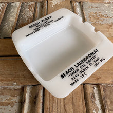 Load image into Gallery viewer, Vintage Beach Plaza &amp; Beach Laundromat Advertising Milk Glass Ashtray c1950s
