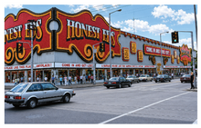 Load image into Gallery viewer, Honest Ed's store front with large sign and people walking on a sidewalk.
